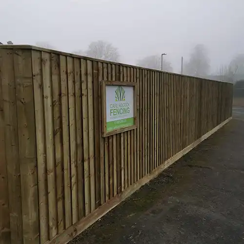 a wooden fence with a sign on it